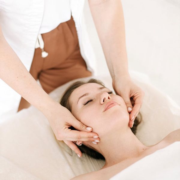 Close-up of a person's serene face with eyes closed, enjoying a moment of peace.